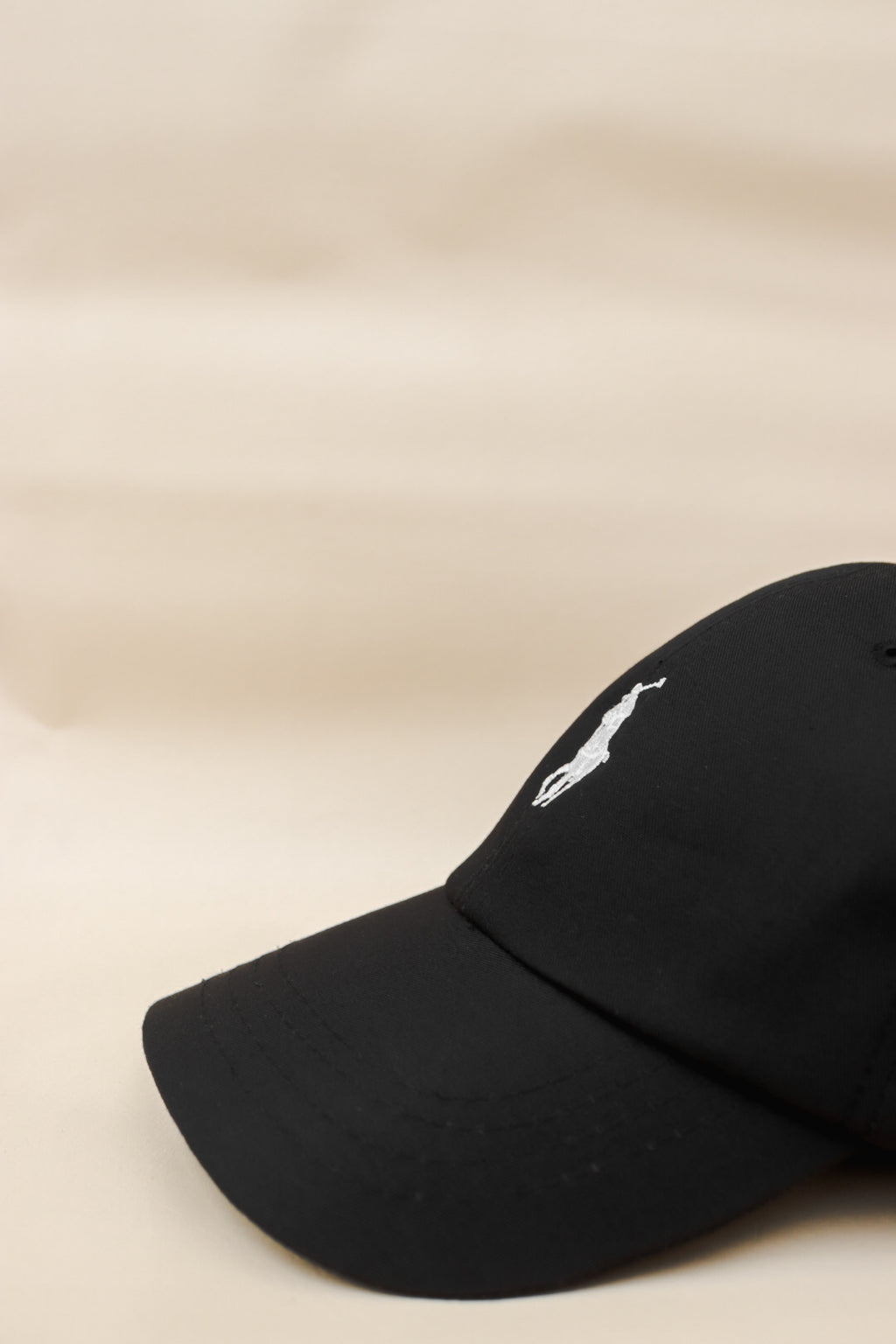 Black polo with white pony