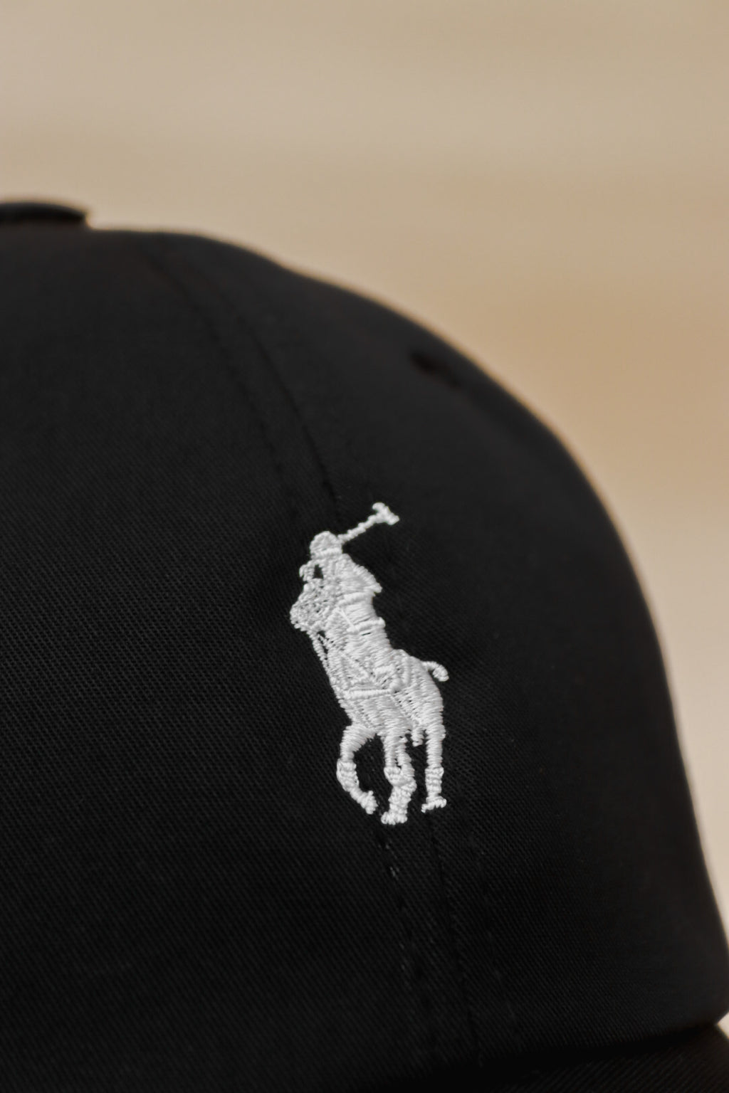 Black polo with white pony